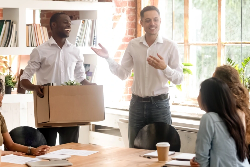 Office workers packing box
