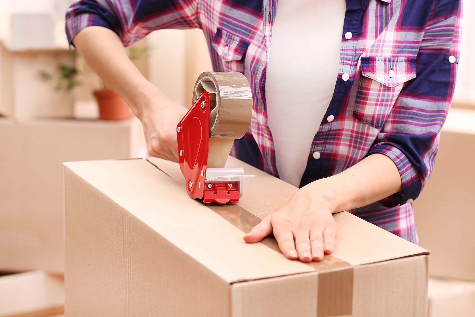 Close-up of packing box being taped shut